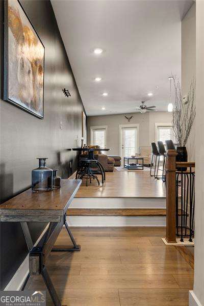 interior space featuring recessed lighting, a ceiling fan, and wood finished floors