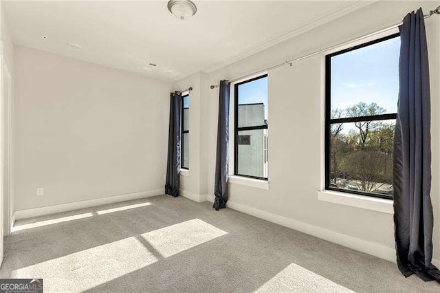 carpeted spare room with baseboards