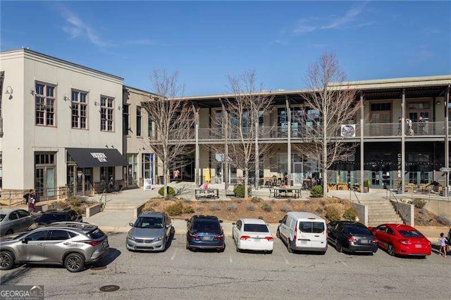 view of building exterior featuring uncovered parking