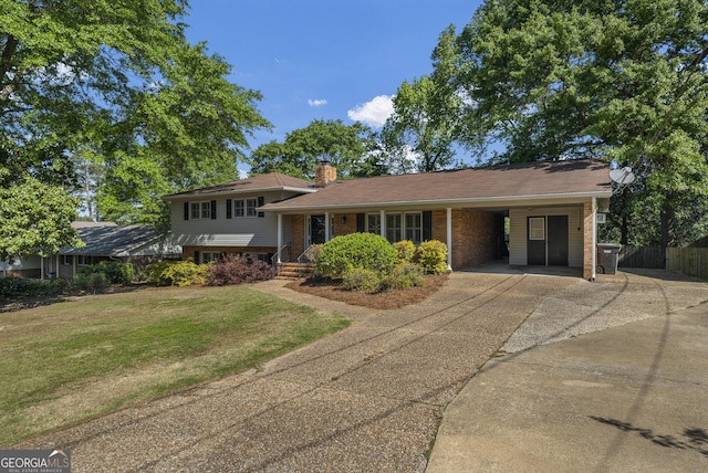 3813 Wingate Dr, Columbus, GA 31909 - tri-level home featuring fence, a front yard, a chimney, concrete driveway, and a carport