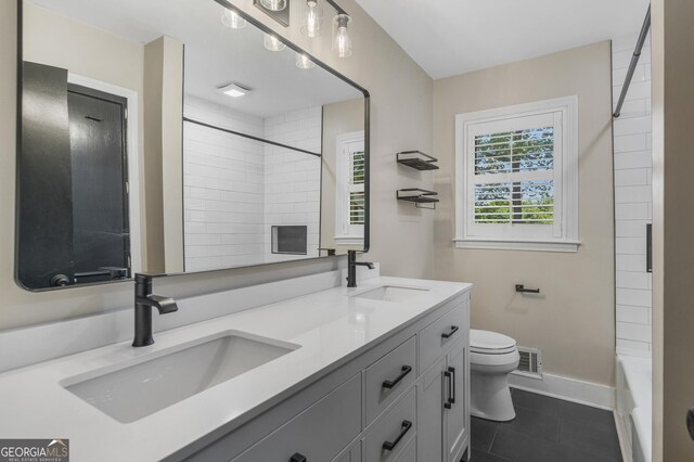 3813 Wingate Dr, Columbus, GA 31909 - full bath with a sink, tile patterned flooring, toilet, and double vanity