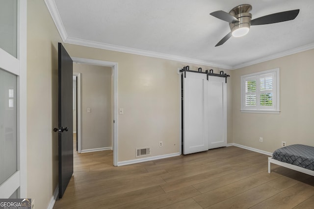 3813 Wingate Dr, Columbus, GA 31909 - unfurnished bedroom with visible vents, ornamental molding, baseboards, and wood finished floors