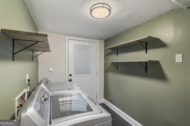 3813 Wingate Dr, Columbus, GA 31909 - laundry room featuring laundry area, a textured ceiling, independent washer and dryer, dark tile patterned flooring, and baseboards