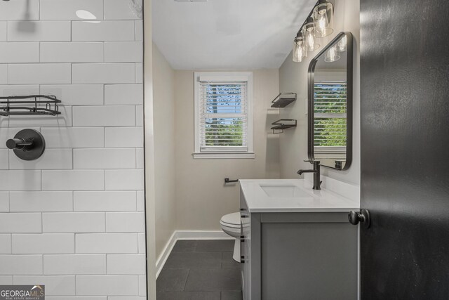 3813 Wingate Dr, Columbus, GA 31909 - bathroom with baseboards, tile patterned flooring, vanity, and a wealth of natural light