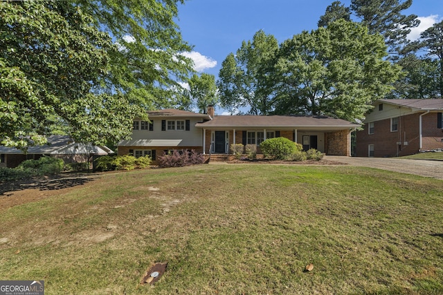 3813 Wingate Dr, Columbus, GA 31909 - tri-level home with a front lawn, an attached carport, a chimney, brick siding, and concrete driveway