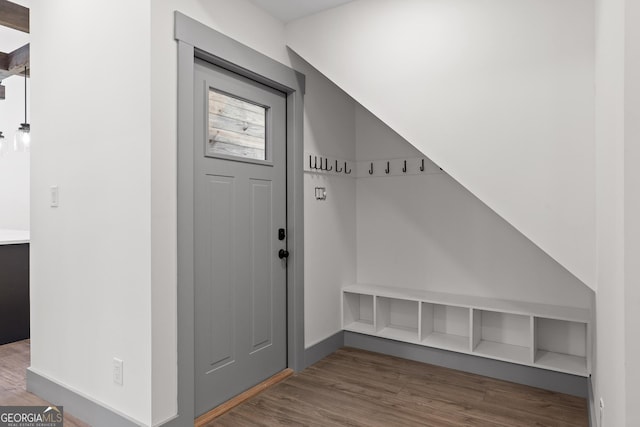 mudroom featuring baseboards and wood finished floors