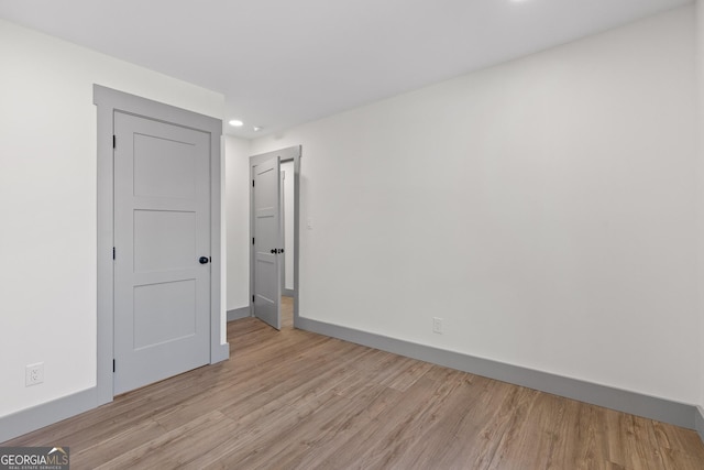 unfurnished bedroom with baseboards, recessed lighting, and light wood-style flooring
