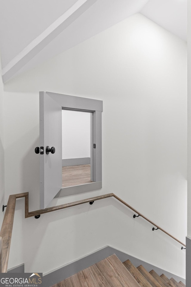 stairs featuring lofted ceiling