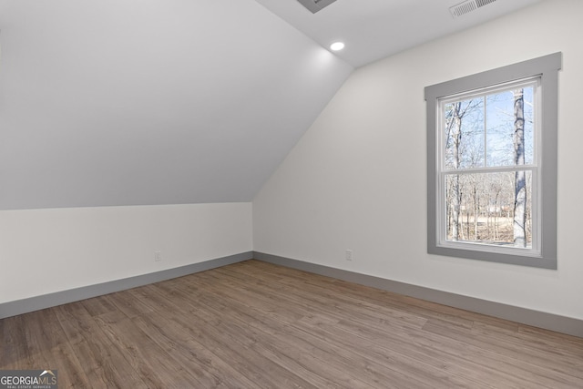 bonus room with visible vents, recessed lighting, baseboards, wood finished floors, and vaulted ceiling