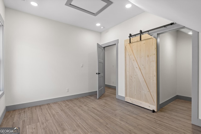unfurnished bedroom with recessed lighting, baseboards, and wood finished floors
