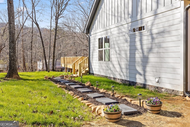 view of side of property with a lawn and board and batten siding