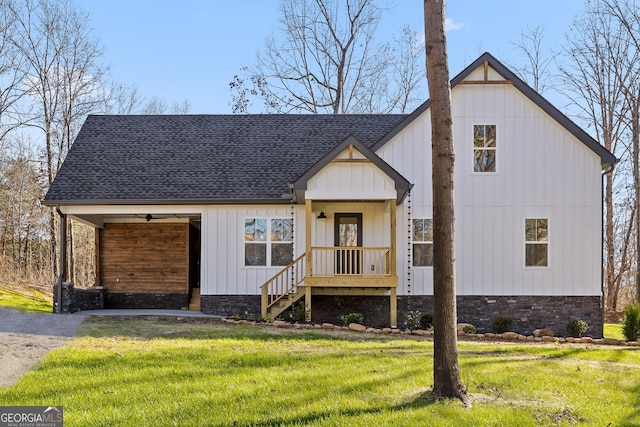 modern farmhouse featuring board and batten siding, a shingled roof, and a front yard