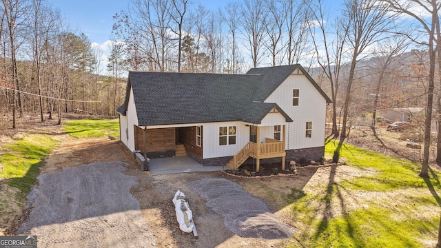 view of front facade with roof with shingles