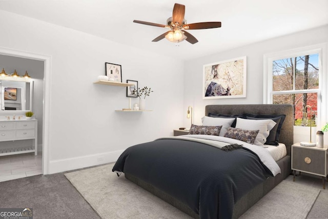 carpeted bedroom featuring baseboards, a ceiling fan, and connected bathroom