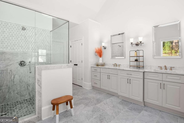 full bath with a sink, baseboards, a shower stall, and double vanity