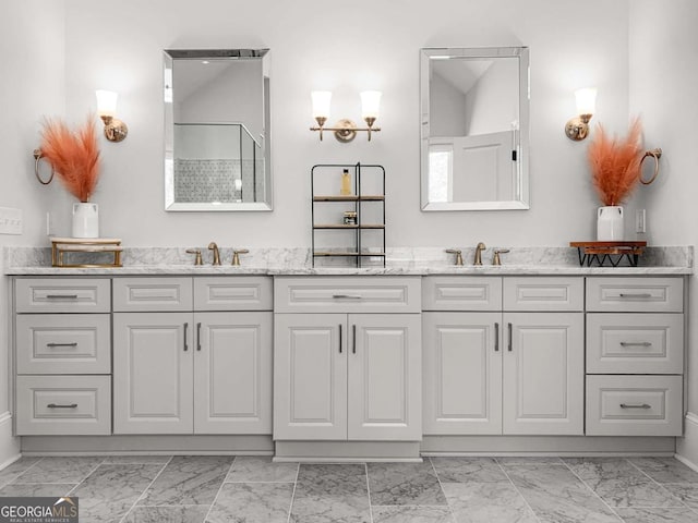 full bath featuring a sink, double vanity, marble finish floor, and a shower