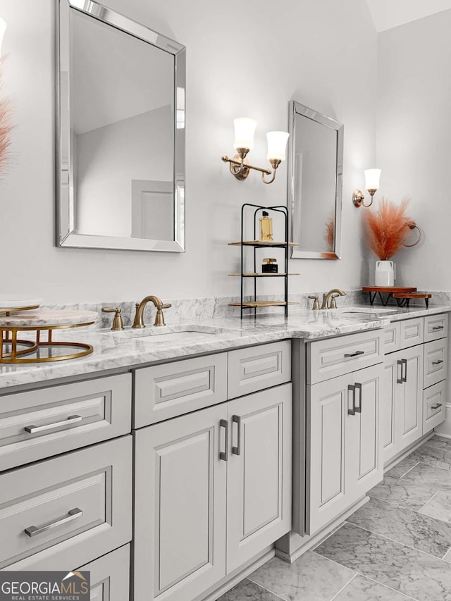 bathroom with double vanity, a sink, and marble finish floor
