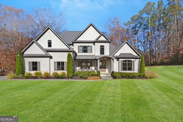 view of front of home featuring a front lawn, metal roof, and a standing seam roof