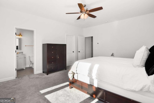 bedroom featuring baseboards, a ceiling fan, carpet flooring, and ensuite bath