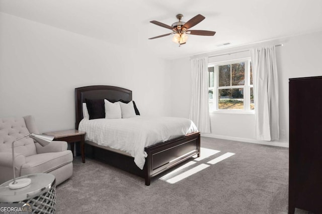 carpeted bedroom featuring baseboards, ceiling fan, and visible vents