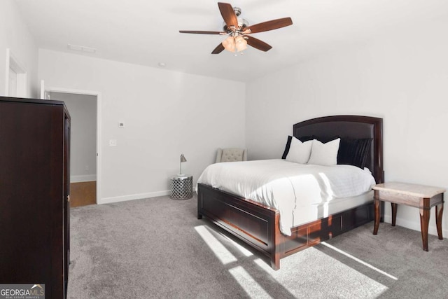carpeted bedroom featuring baseboards and ceiling fan
