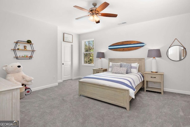 carpeted bedroom with baseboards, ceiling fan, and visible vents