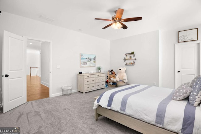 bedroom featuring baseboards, ceiling fan, and carpet
