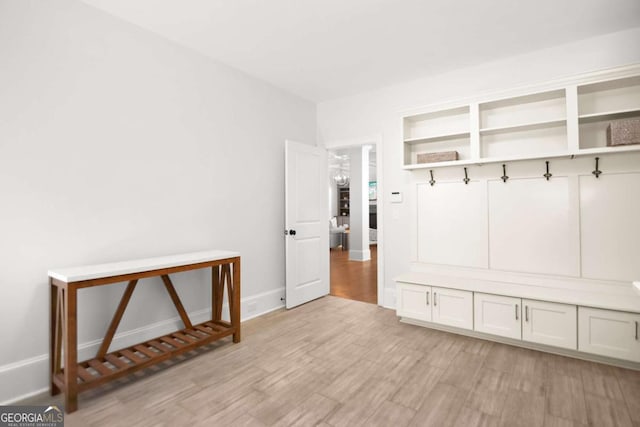 mudroom with baseboards and light wood-style flooring