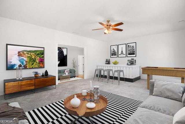 carpeted living room featuring ceiling fan