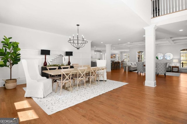 dining room featuring recessed lighting, decorative columns, and wood finished floors