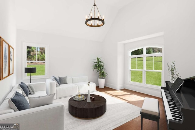 living area featuring baseboards, wood finished floors, a notable chandelier, and high vaulted ceiling