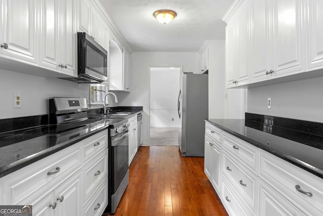 380 Grady Ave, Fayetteville, GA 30214 - kitchen featuring a sink, white cabinetry, dark wood-style floors, and stainless steel appliances