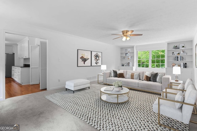 380 Grady Ave, Fayetteville, GA 30214 - carpeted living room with a ceiling fan, baseboards, visible vents, and built in shelves