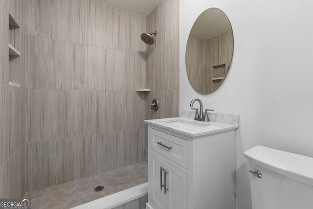 380 Grady Ave, Fayetteville, GA 30214 - bathroom featuring vanity, toilet, and tiled shower