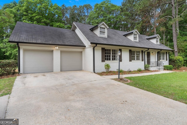 380 Grady Ave, Fayetteville, GA 30214 - new england style home with a front lawn, roof with shingles, brick siding, concrete driveway, and an attached garage