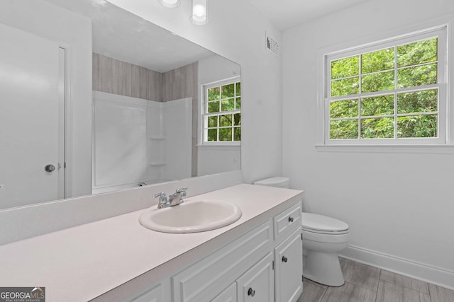 380 Grady Ave, Fayetteville, GA 30214 - bathroom with visible vents, walk in shower, vanity, baseboards, and toilet
