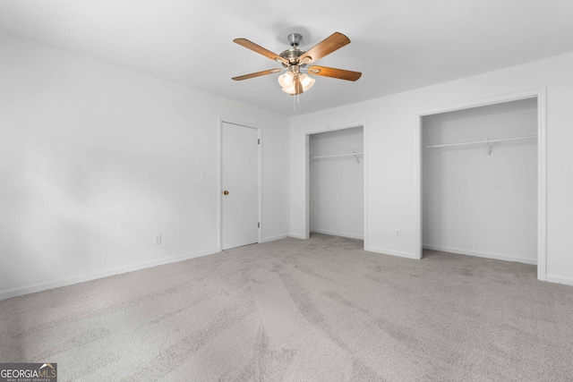 380 Grady Ave, Fayetteville, GA 30214 - unfurnished bedroom with a ceiling fan, baseboards, carpet, and two closets