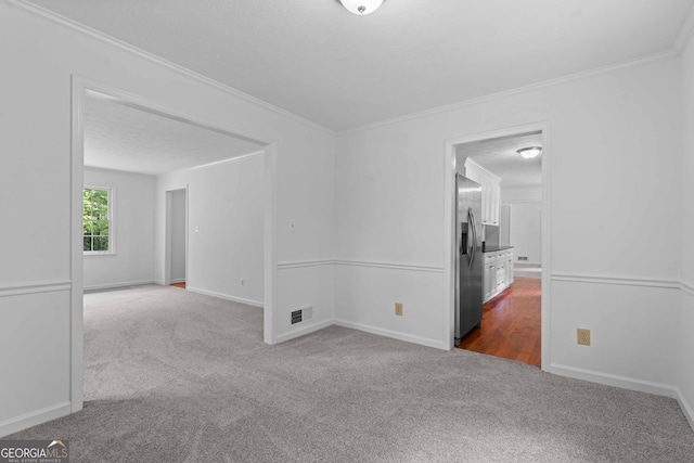 380 Grady Ave, Fayetteville, GA 30214 - spare room with visible vents, ornamental molding, baseboards, and dark colored carpet