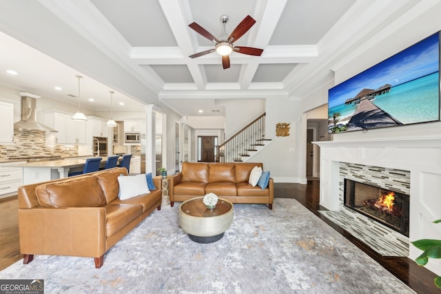 living room featuring ceiling fan, a fireplace, coffered ceiling, and recessed lighting