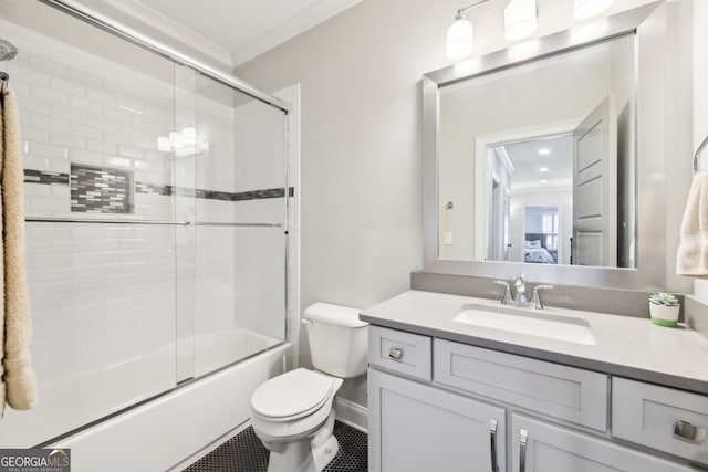 bathroom featuring vanity, ornamental molding, bath / shower combo with glass door, and toilet