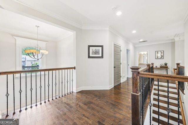 hallway featuring a notable chandelier, recessed lighting, baseboards, an upstairs landing, and wood finished floors