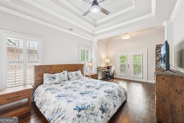 bedroom featuring visible vents, access to exterior, dark wood-type flooring, a tray ceiling, and french doors