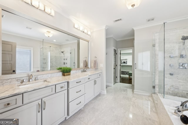 bathroom featuring visible vents, ornamental molding, a sink, and a stall shower