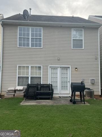 back of property featuring a patio and a yard