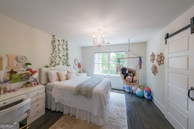 150 Shady Grove Ln, Alpharetta, GA 30009 - bedroom featuring a chandelier, a barn door, dark wood-type flooring, and baseboards