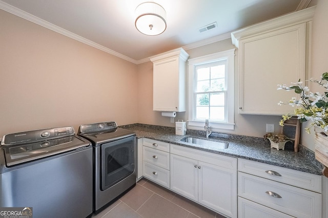 150 Shady Grove Ln, Alpharetta, GA 30009 - laundry room featuring washing machine and clothes dryer, crown molding, cabinet space, and dark tile patterned flooring