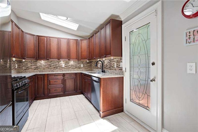 kitchen featuring stainless steel dishwasher, lofted ceiling with skylight, gas stove, a sink, and decorative backsplash