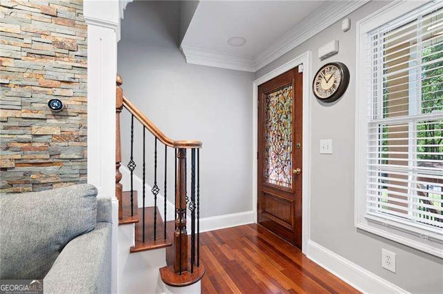 entryway featuring crown molding, dark wood finished floors, baseboards, and stairs