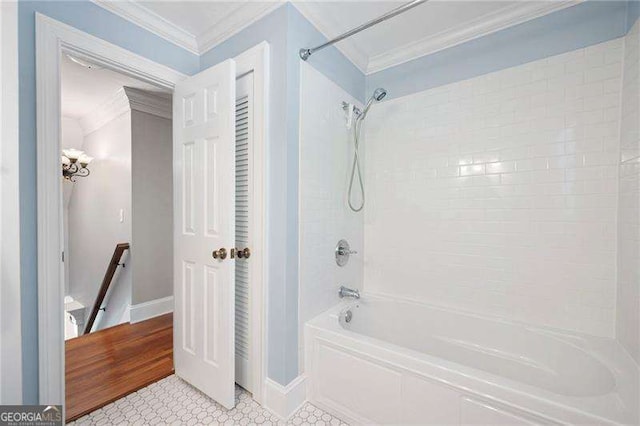 bathroom with ornamental molding, shower / tub combination, and baseboards