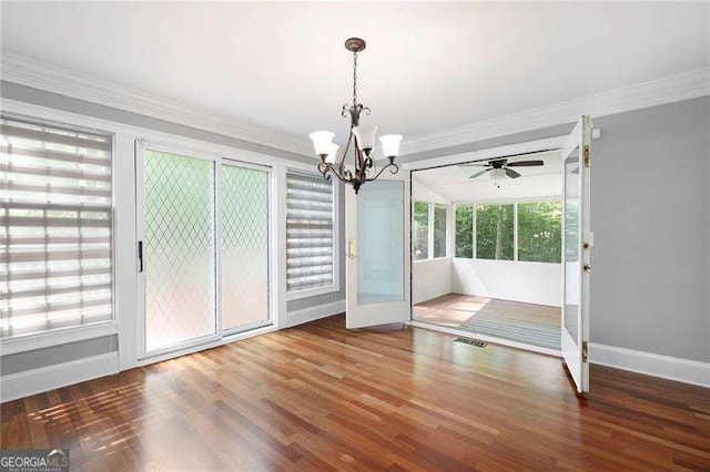 unfurnished dining area featuring baseboards, a chandelier, crown molding, and wood finished floors